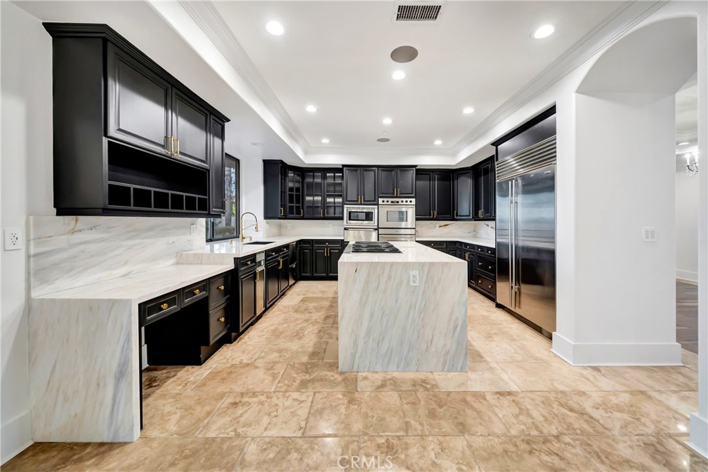 4165 Elm View Encino, CA 91316 - Photo 25 of 49 a large kitchen with kitchen island a sink a counter top space cabinets and stainless steel appliances