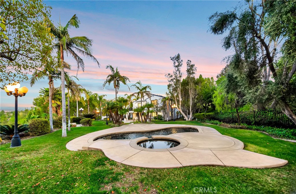 4165 Elm View Encino, CA 91316 - Photo 46 of 49 a backyard of a house with table and chairs plants and large trees