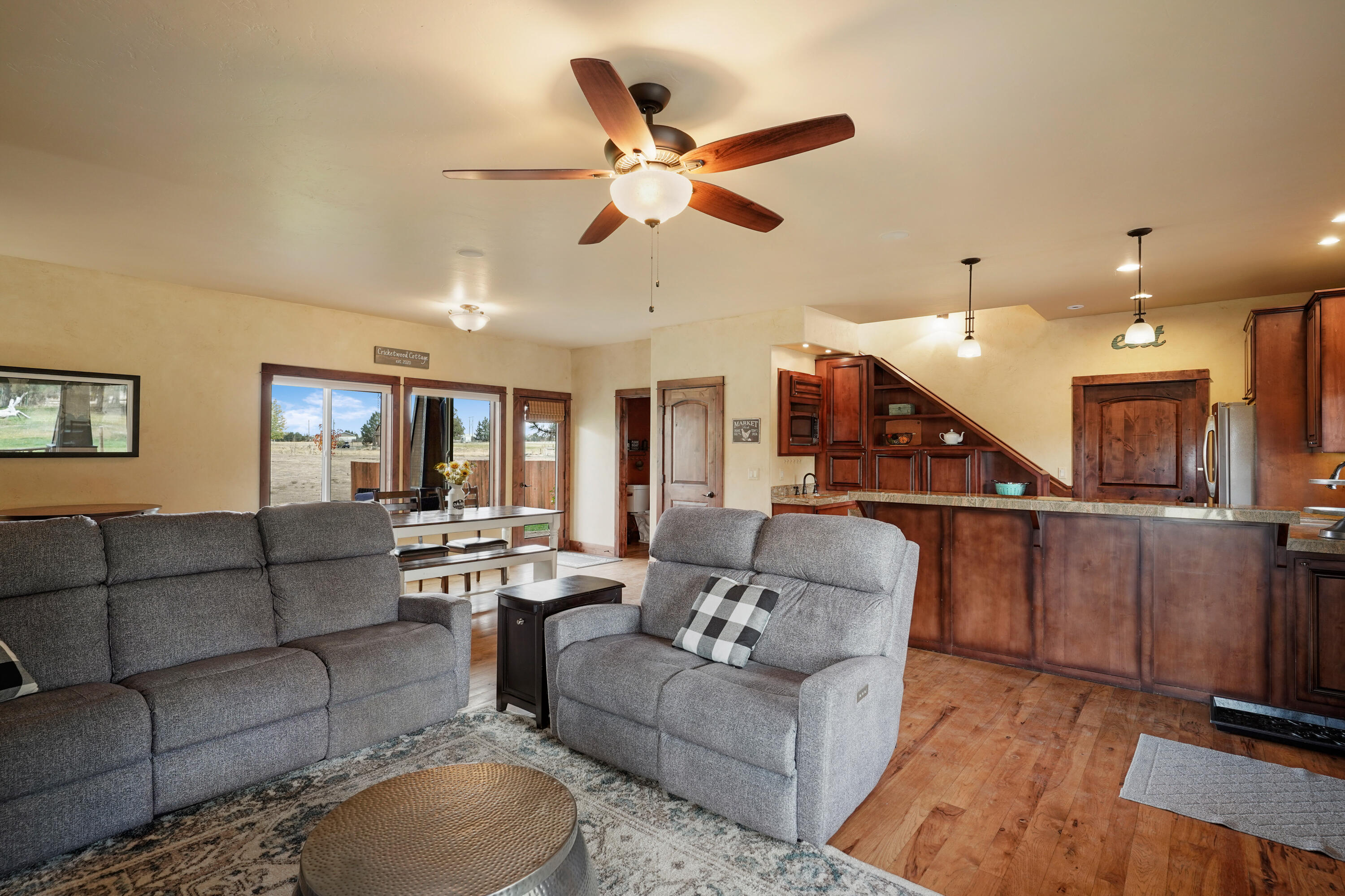 63520 Cricketwood Road Bend, OR 97701 - Photo 61 of 84 a living room with furniture kitchen view and a chandelier