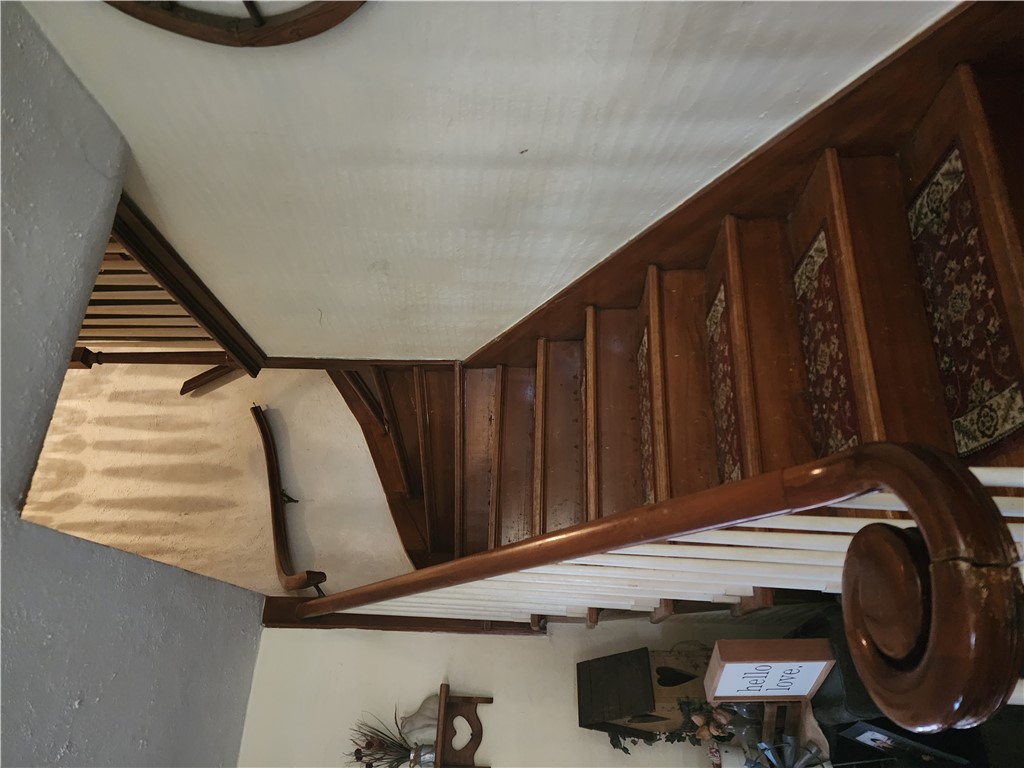 1436 Ruskin Road Dayton, OH 45406 - Photo 18 of 29 Elegant wooden staircase featuring carved banister, adding architectural character to the home.