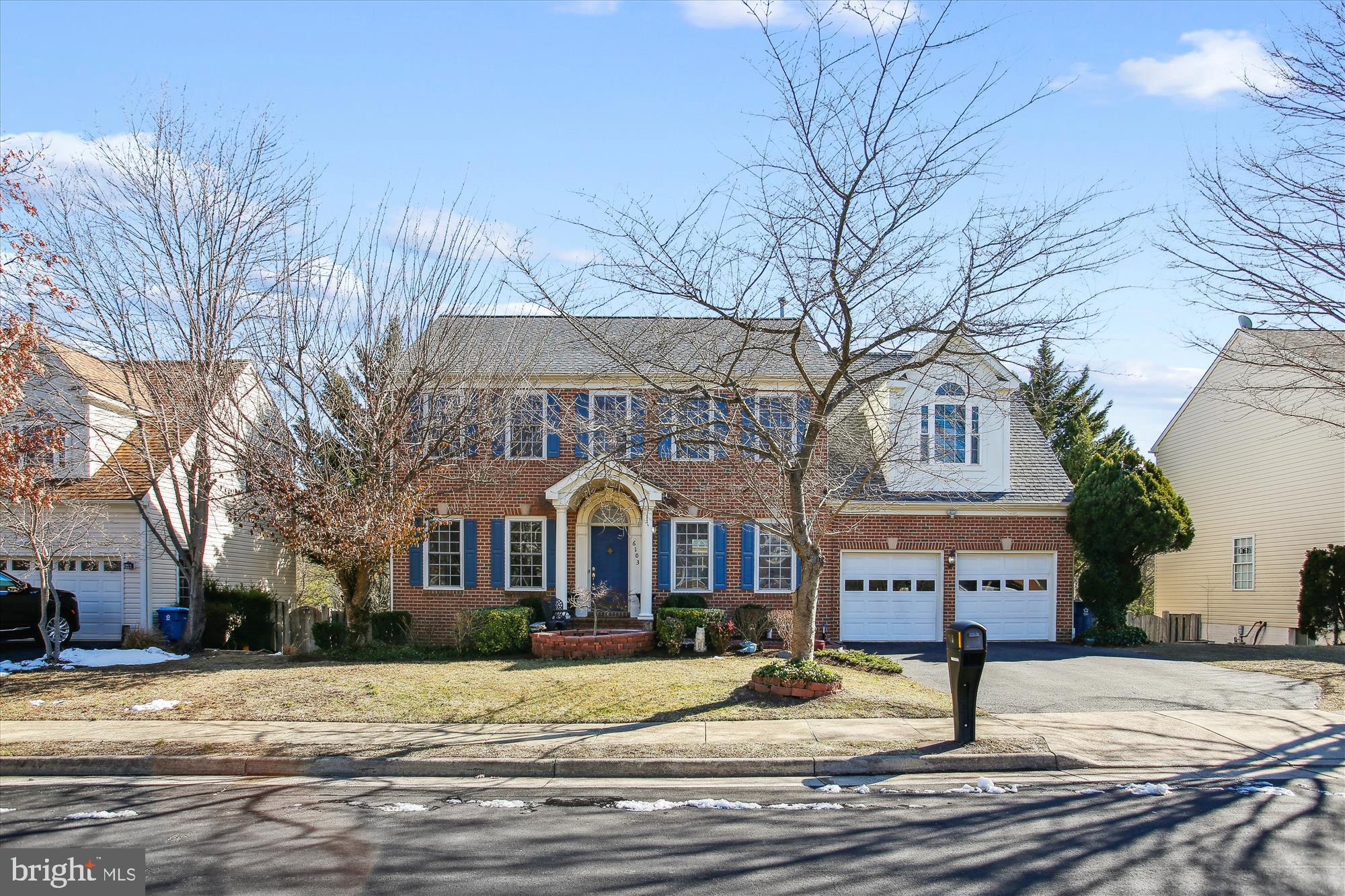 6103 Deer Ridge Trail Springfield, VA 22150 - Photo 1 of 36 a front view of residential houses with yard and trees