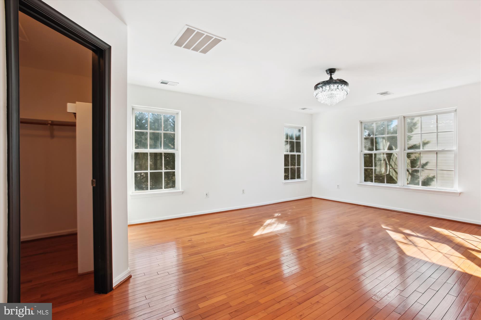 6103 Deer Ridge Trail Springfield, VA 22150 - Photo 12 of 36 a view of an empty room with wooden floor and a window