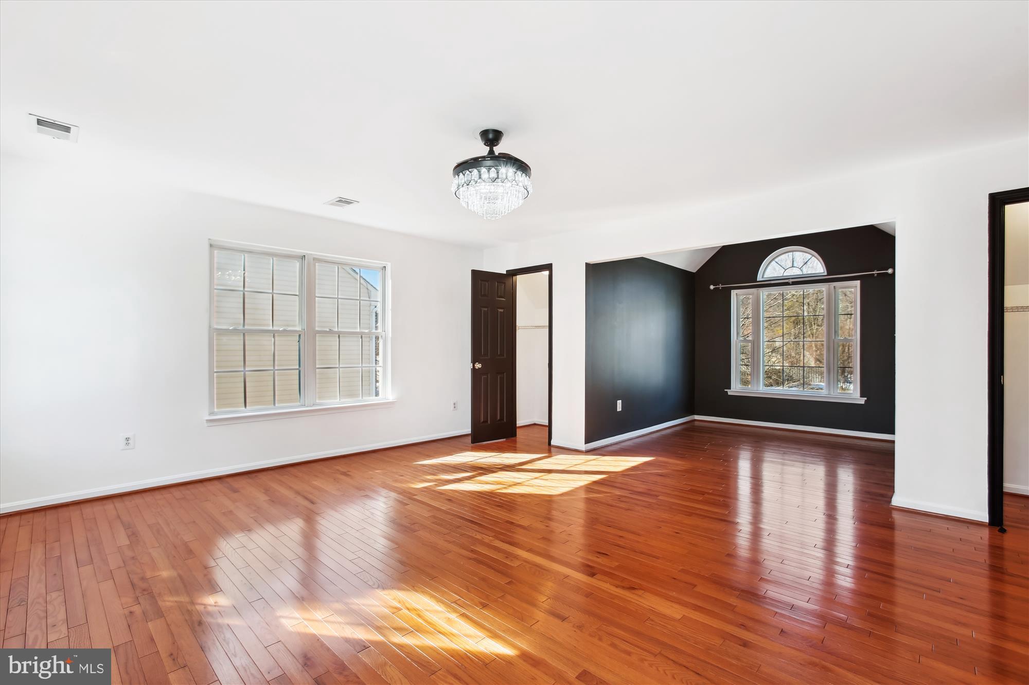 6103 Deer Ridge Trail Springfield, VA 22150 - Photo 13 of 36 a view of an empty room with a window and wooden floor