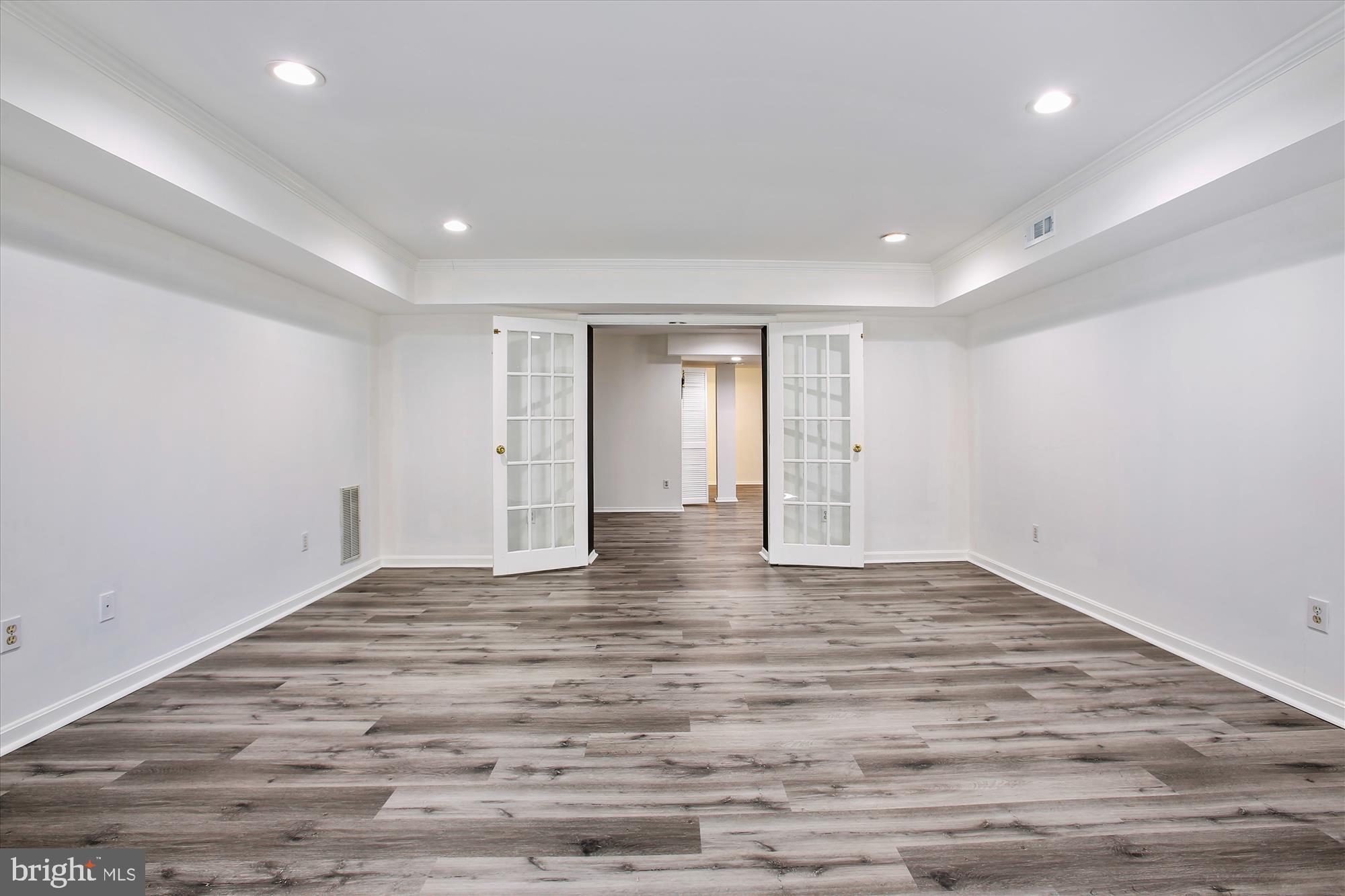 6103 Deer Ridge Trail Springfield, VA 22150 - Photo 19 of 36 a view of an empty room with wooden floor