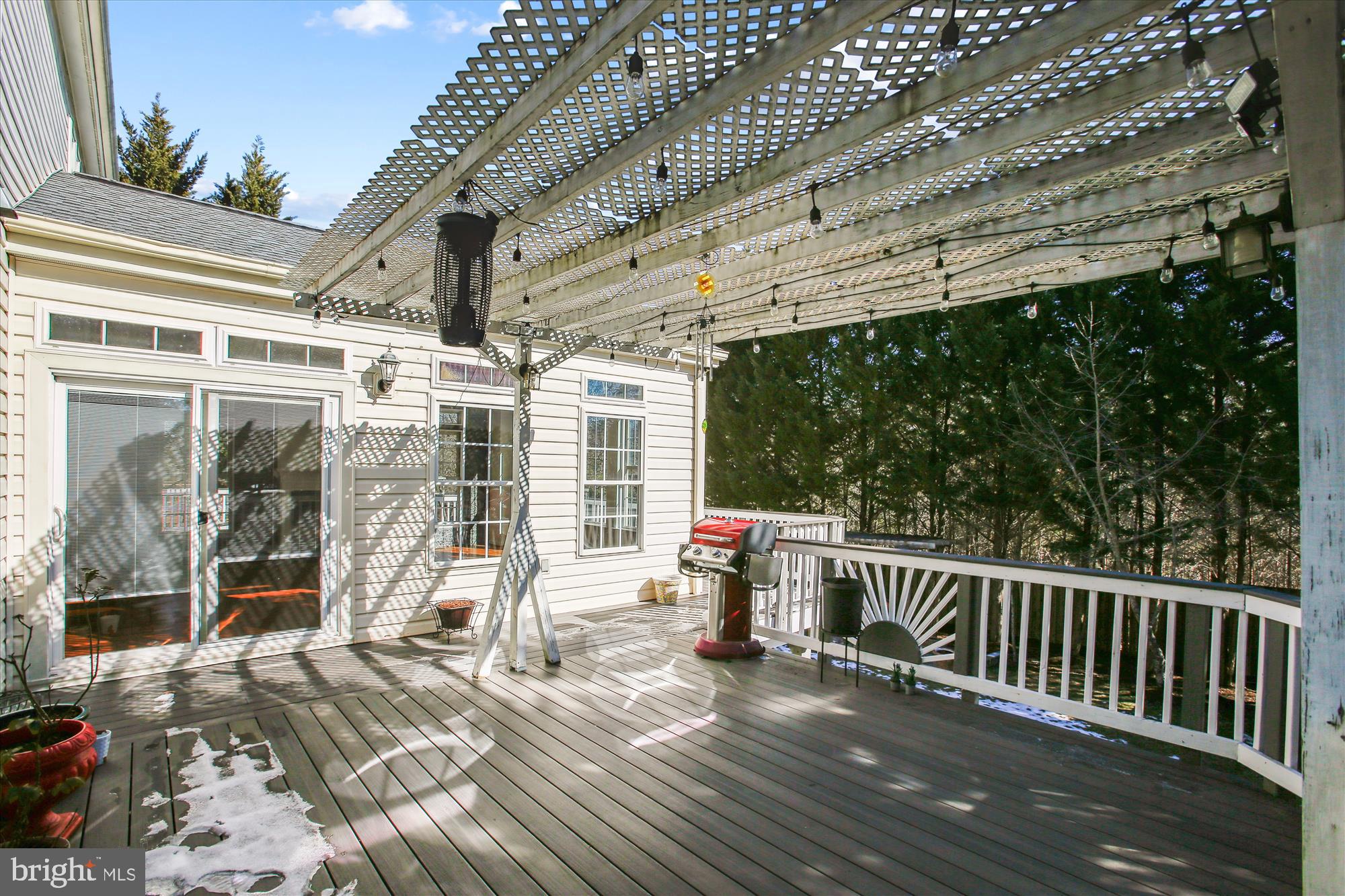 6103 Deer Ridge Trail Springfield, VA 22150 - Photo 23 of 36 a porch with a table chairs and wooden floor