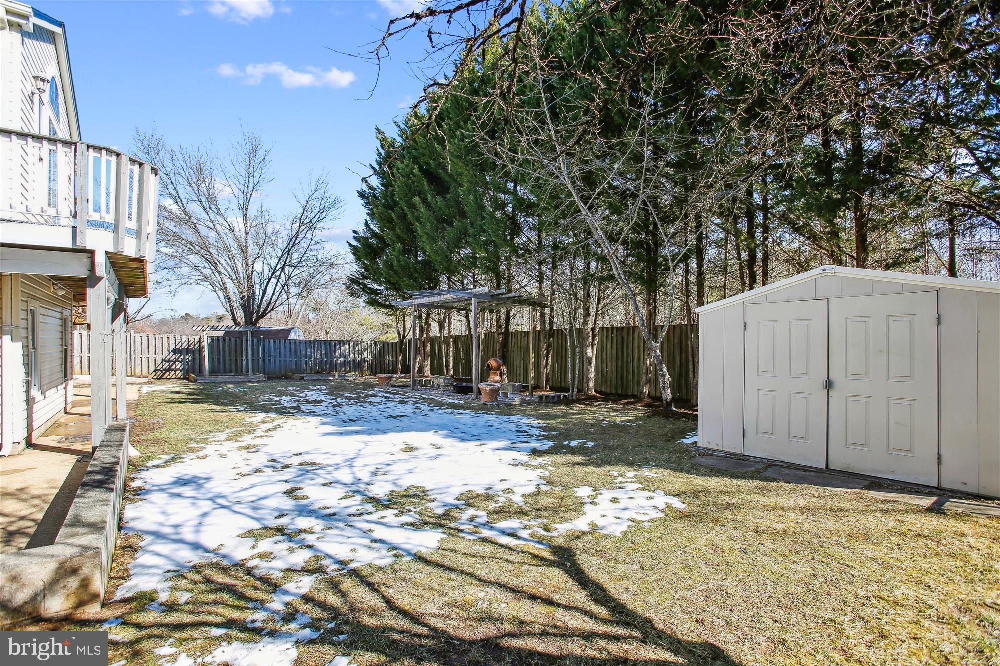 6103 Deer Ridge Trail Springfield, VA 22150 - Photo 25 of 36 a view of a house with a yard covered in snow
