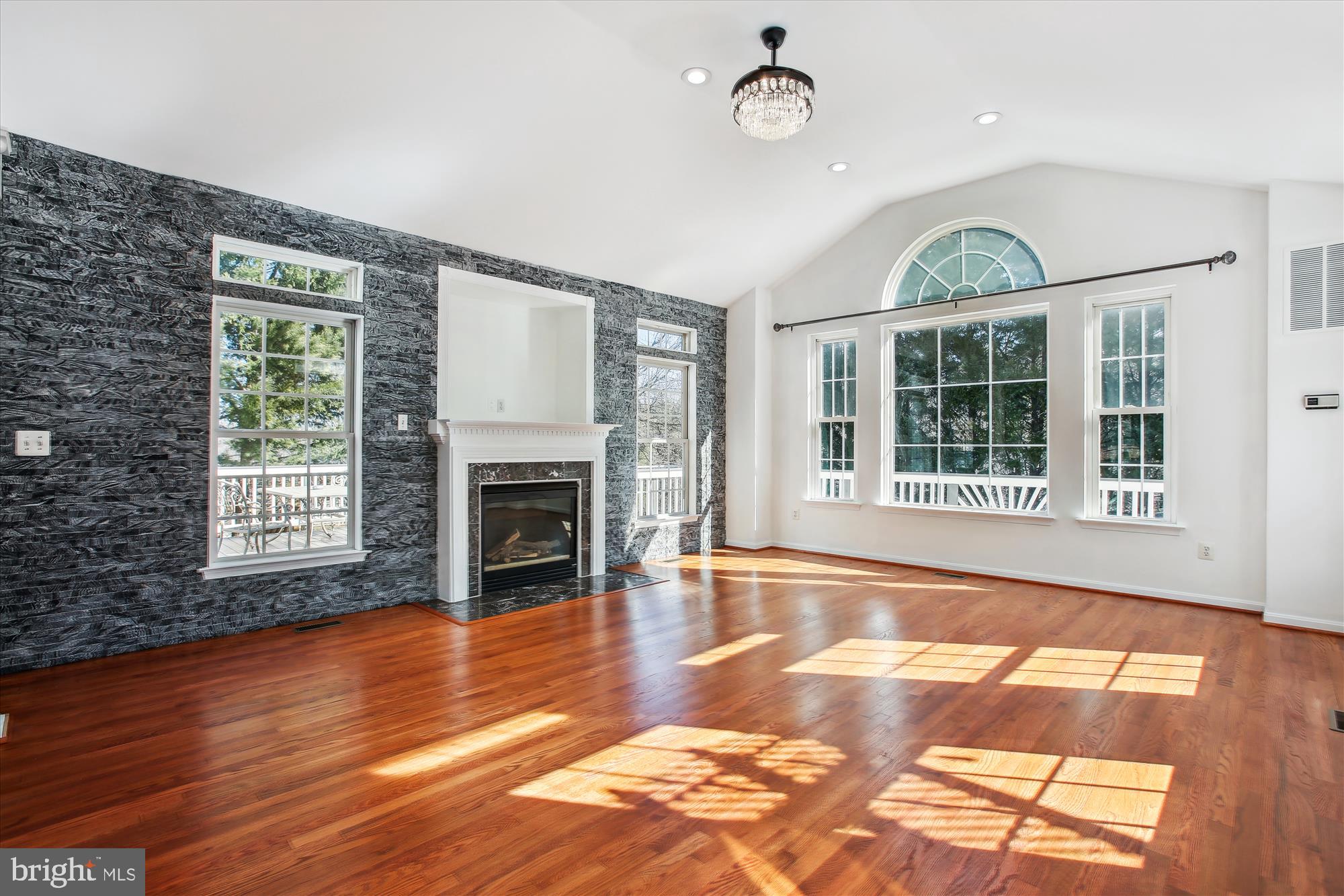 6103 Deer Ridge Trail Springfield, VA 22150 - Photo 5 of 36 a view of an empty room with wooden floor and a window