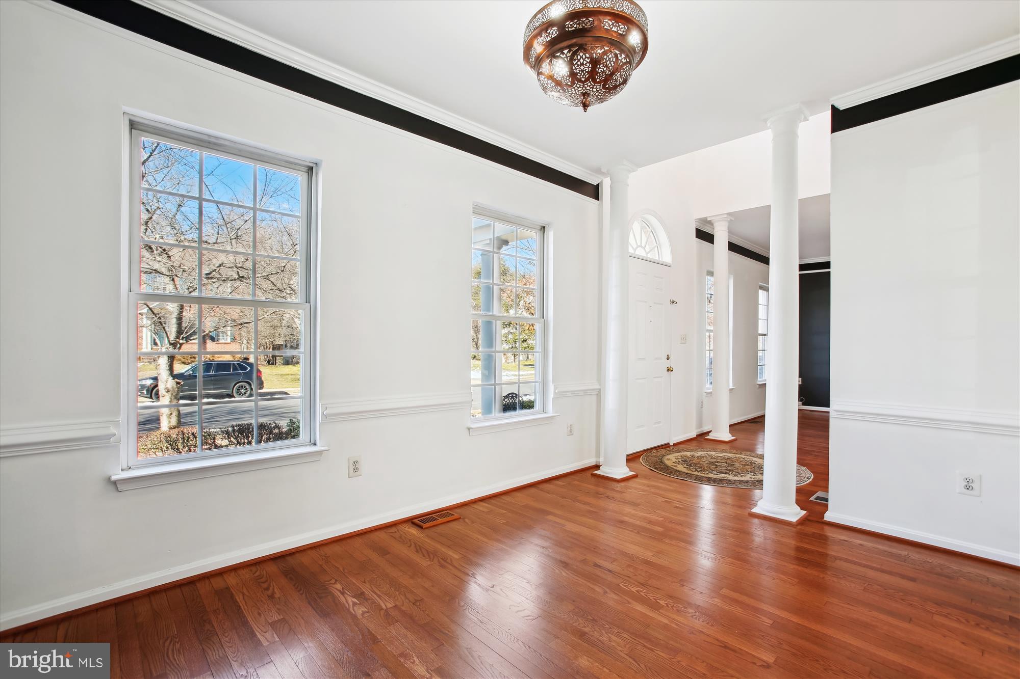 6103 Deer Ridge Trail Springfield, VA 22150 - Photo 6 of 36 a view of an empty room with wooden floor and a window
