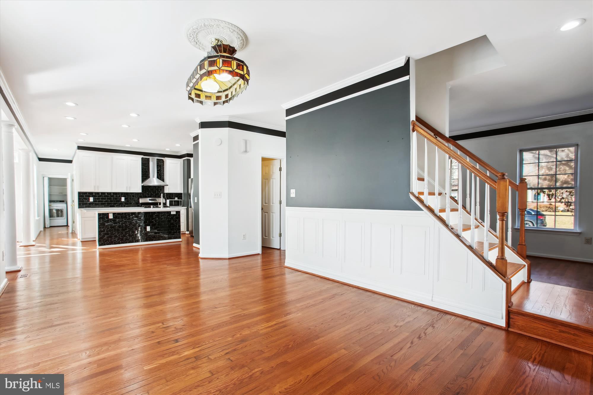 6103 Deer Ridge Trail Springfield, VA 22150 - Photo 8 of 36 a view of a hallway with wooden floor windows and kitchen view