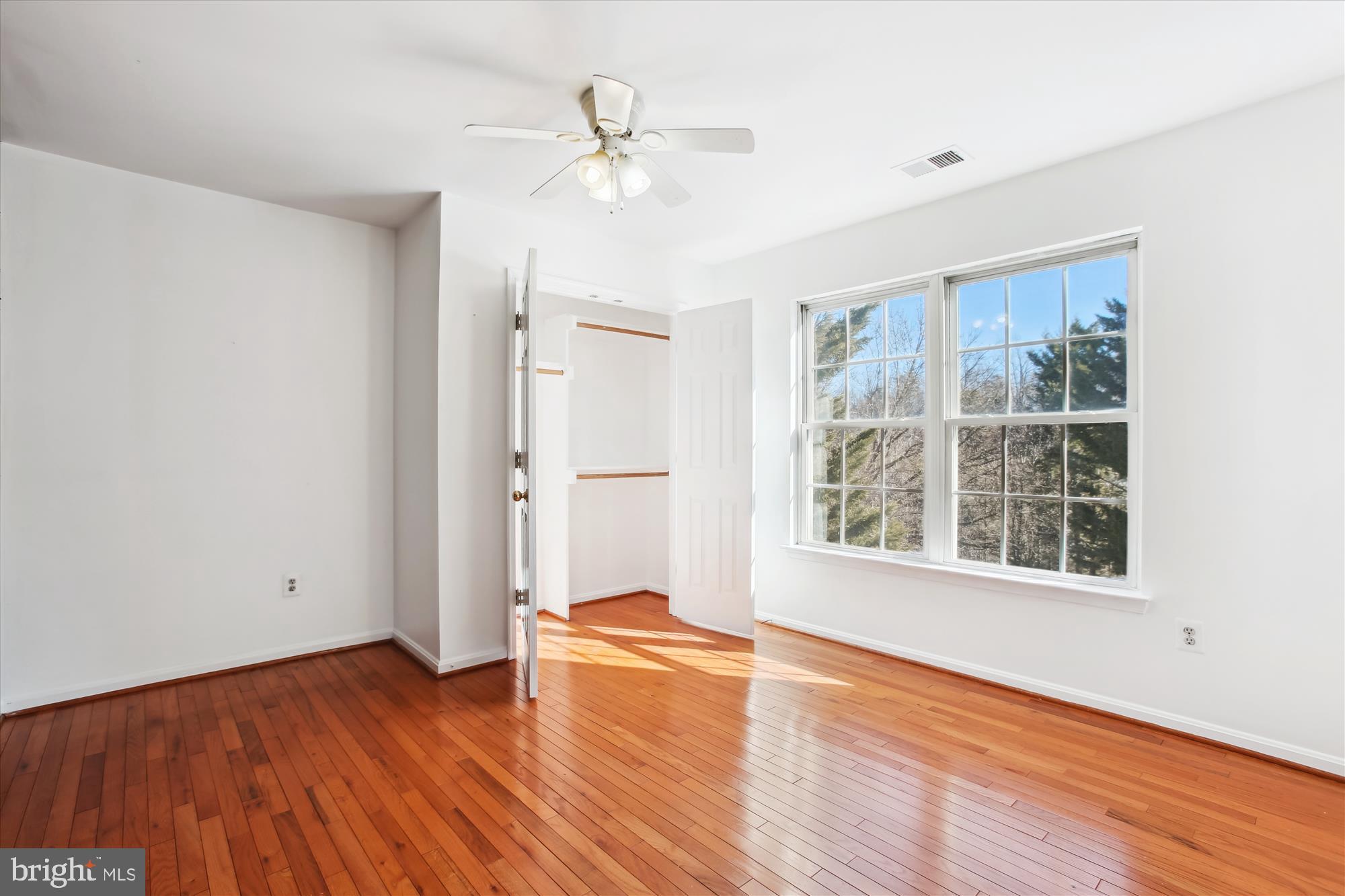 6103 Deer Ridge Trail Springfield, VA 22150 - Photo 9 of 36 an empty room with wooden floor and windows