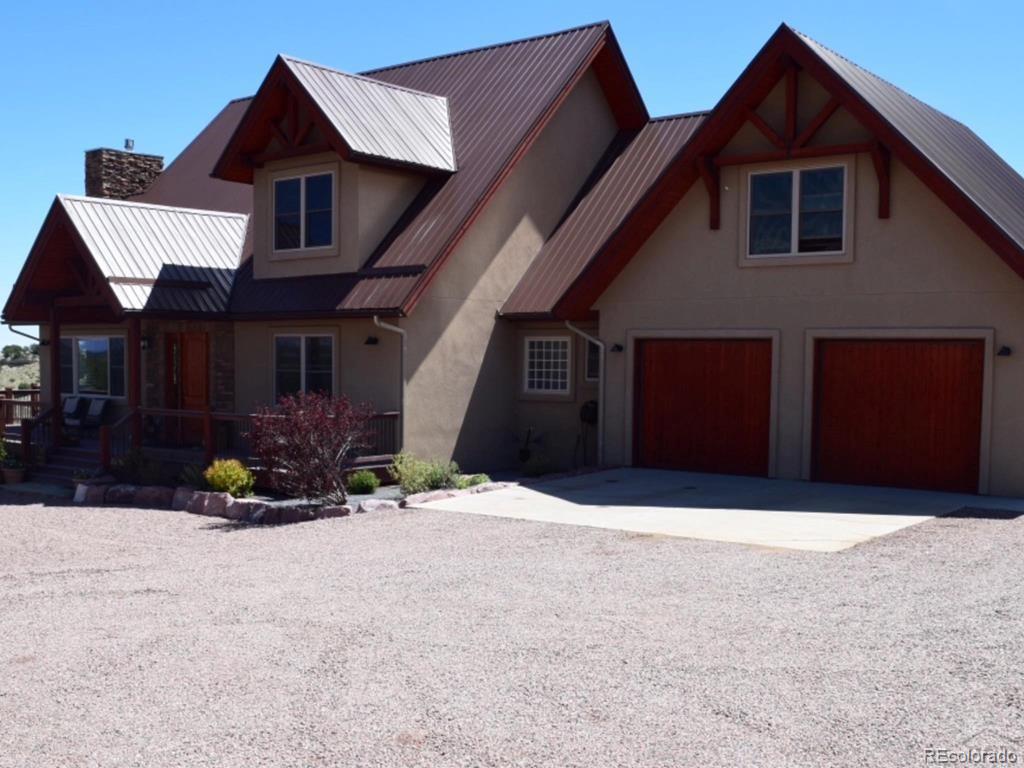 9780 Canyon Point Drive Rye, CO 81069 - Photo 1 of 35 a front view of a house with a yard