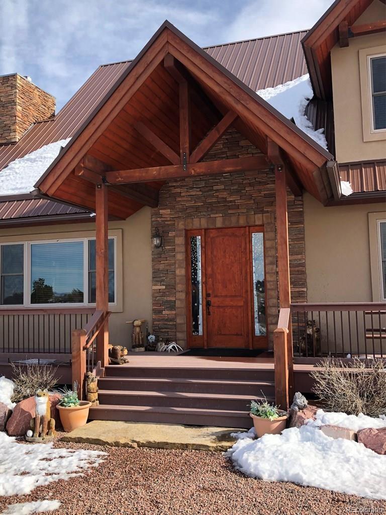 9780 Canyon Point Drive Rye, CO 81069 - Photo 12 of 35 a front view of a house with a bench