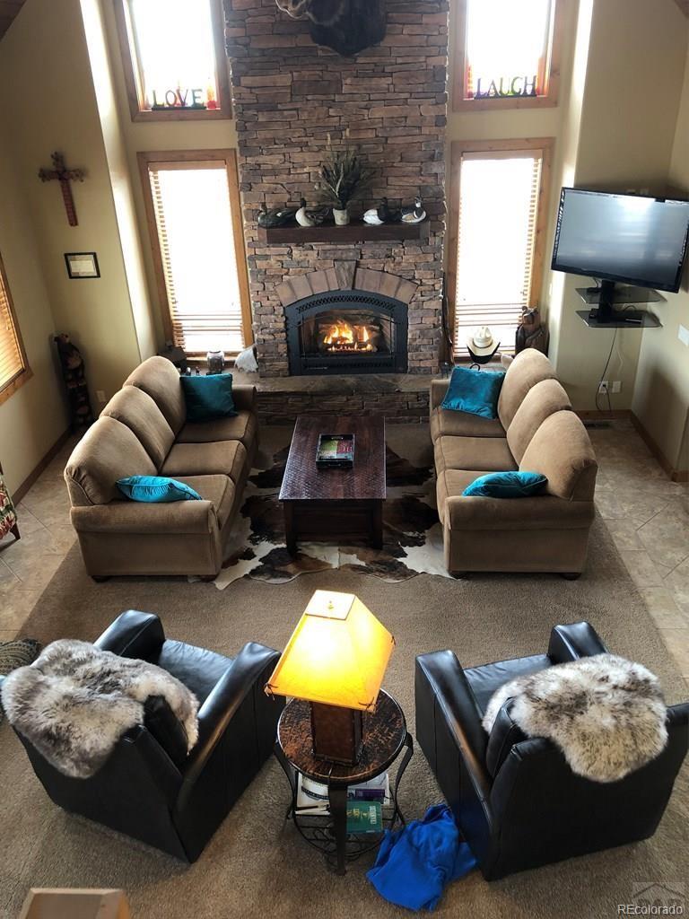 9780 Canyon Point Drive Rye, CO 81069 - Photo 3 of 35 a living room with furniture and a fireplace