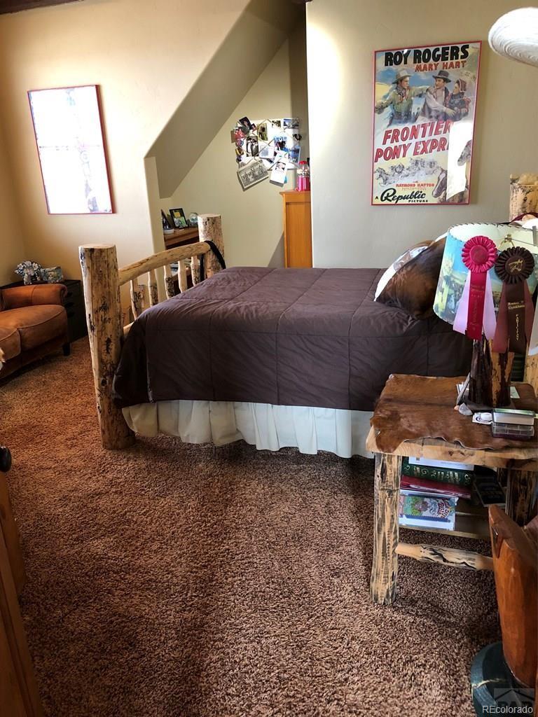9780 Canyon Point Drive Rye, CO 81069 - Photo 33 of 35 a bedroom with a bed and dresser