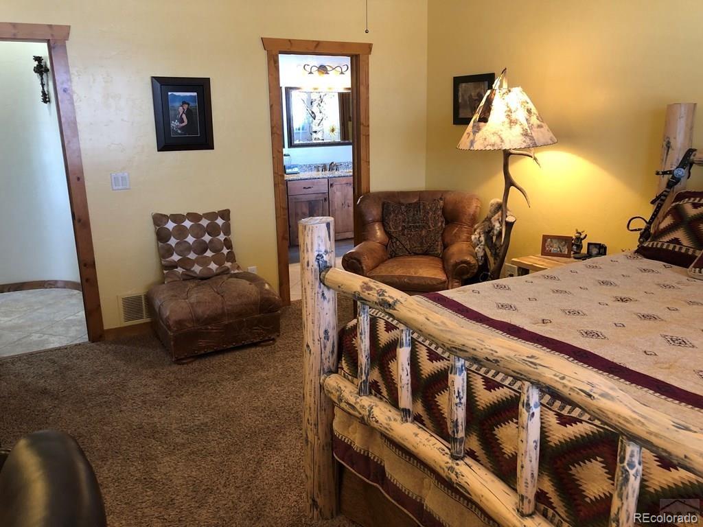 9780 Canyon Point Drive Rye, CO 81069 - Photo 5 of 35 a bedroom with furniture and a wooden floor