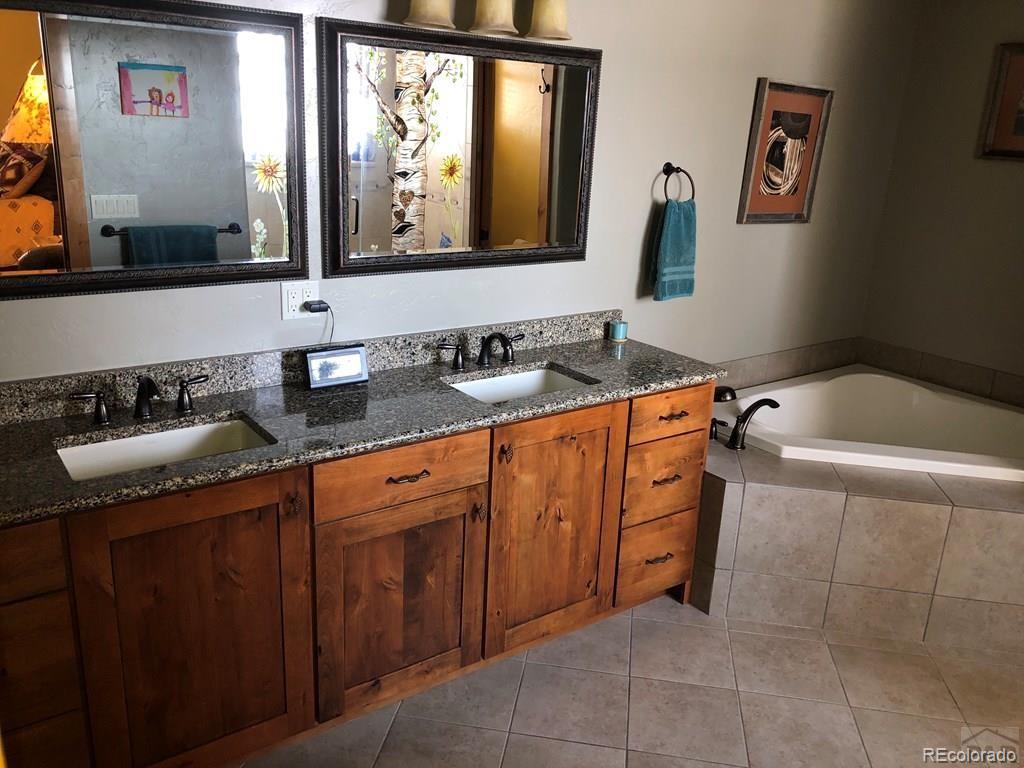 9780 Canyon Point Drive Rye, CO 81069 - Photo 6 of 35 a bathroom with a sink and a mirror