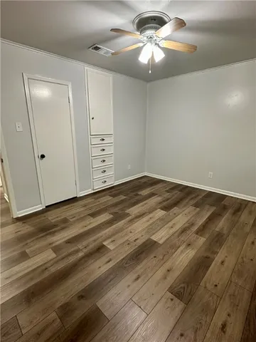 a bathroom with a granite countertop toilet sink mirror and shower