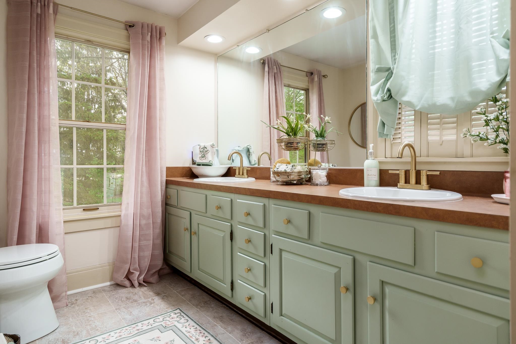 10562 Town Hall Road Belvidere, IL 61008 - Photo 41 of 72 a bathroom with a double vanity sink a mirror and a toilet