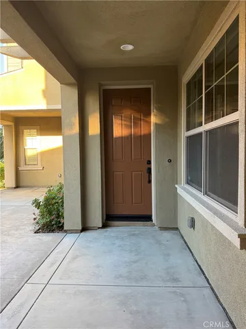 a view of a house with sitting area and potted plants