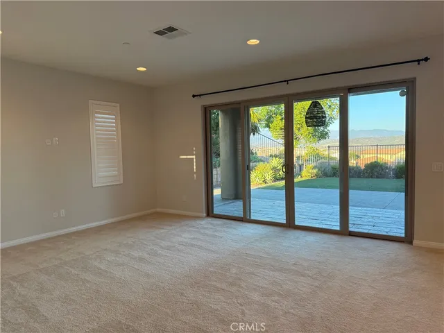 an empty room with large windows