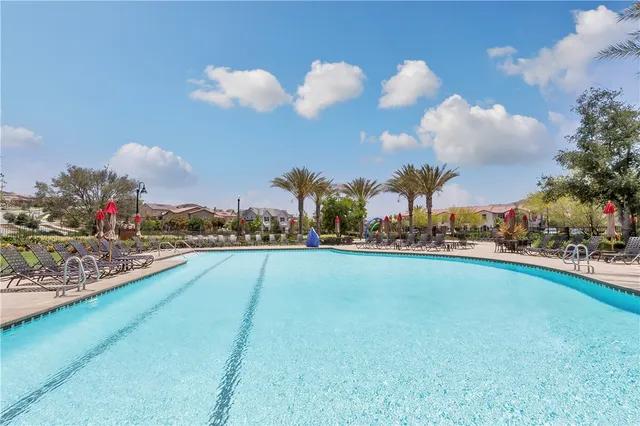 a swimming pool with outdoor seating and yard