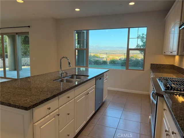 a kitchen with a sink and large window