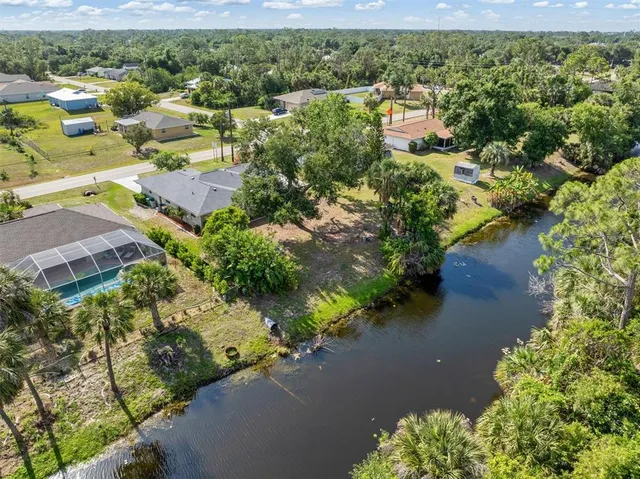 a kitchen with stainless steel appliances kitchen island granite countertop a refrigerator and a sink