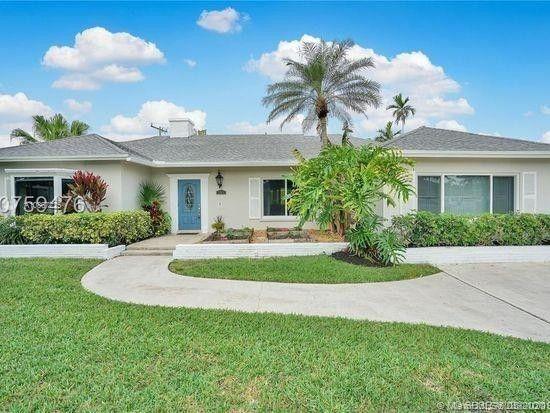 261 Northwest 11th Avenue Boca Raton, FL 33486 - Photo 14 of 14 a front view of a house with a yard and potted plants