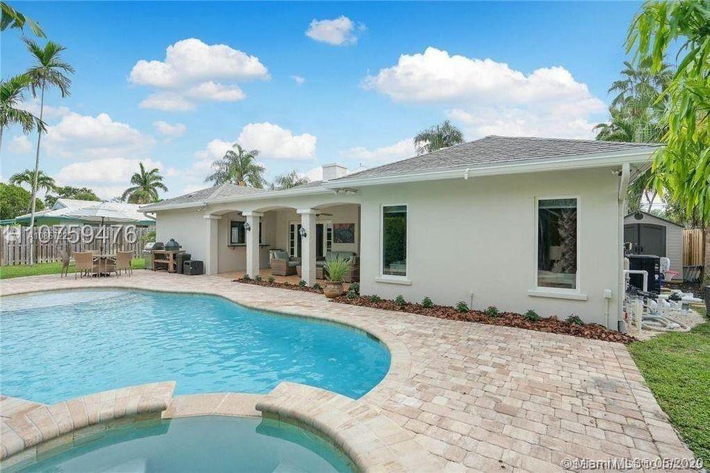 261 Northwest 11th Avenue Boca Raton, FL 33486 - Photo 4 of 14 a view of house with yard outdoor seating and barbeque oven