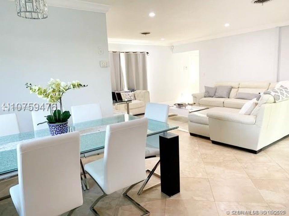 261 Northwest 11th Avenue Boca Raton, FL 33486 - Photo 8 of 14 a living room with furniture a chandelier and a table