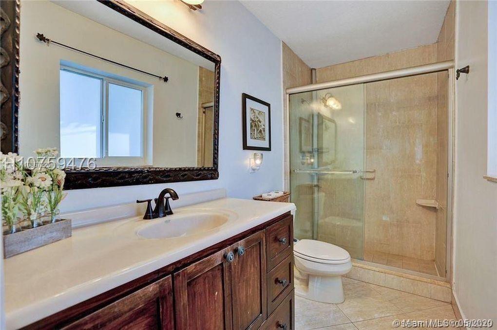 261 Northwest 11th Avenue Boca Raton, FL 33486 - Photo 9 of 14 a bathroom with a sink a toilet and shower
