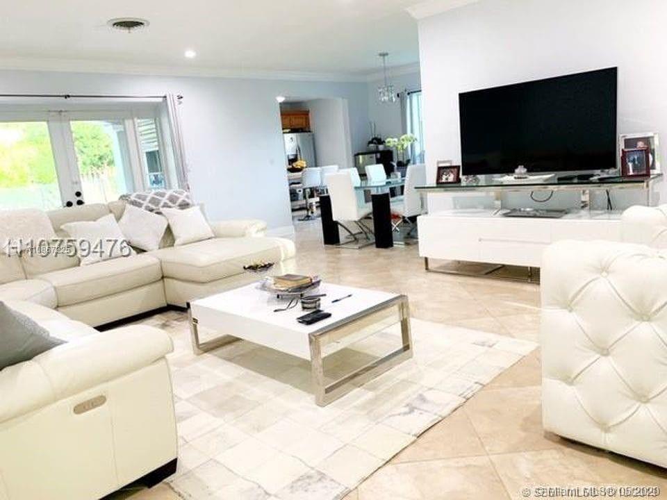 261 Northwest 11th Avenue Boca Raton, FL 33486 - Photo 10 of 14 a living room with furniture and a flat screen tv