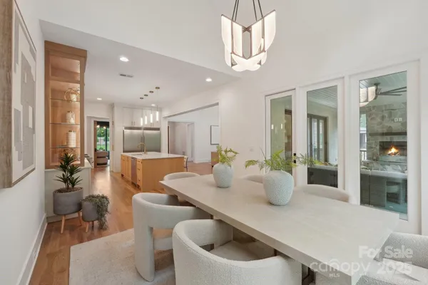a dining room with furniture and wooden floor