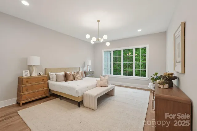 a spacious bedroom with a bed and a large window