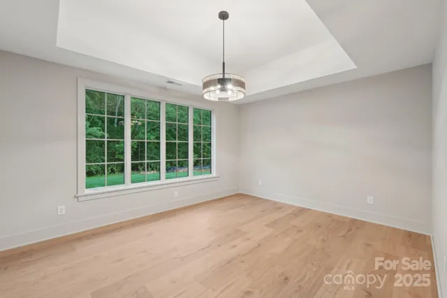 a living room with a large window and a glass door
