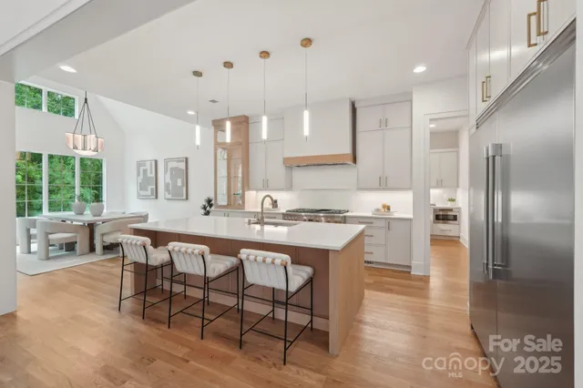 a large kitchen with a table and chairs