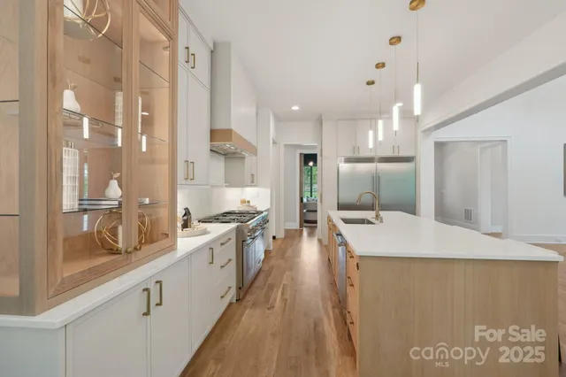 a large white kitchen with a large window