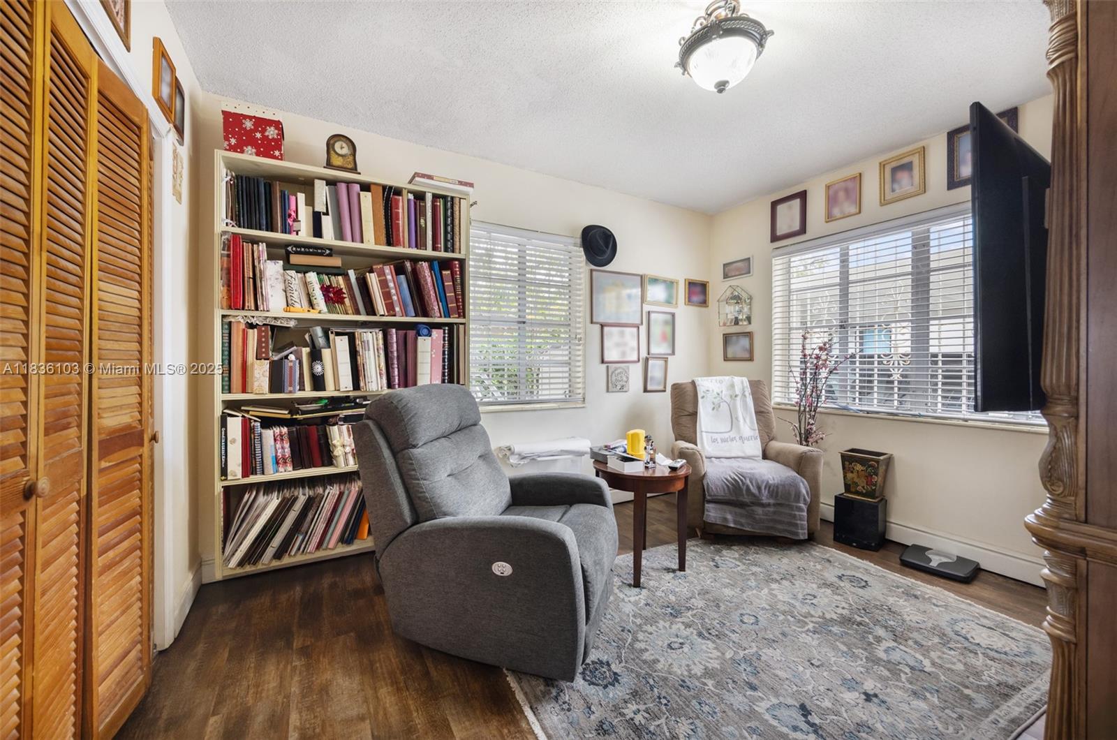 811 Southwest 25th Road Miami, FL 33129 - Photo 18 of 23 a living room with furniture and a book shelf