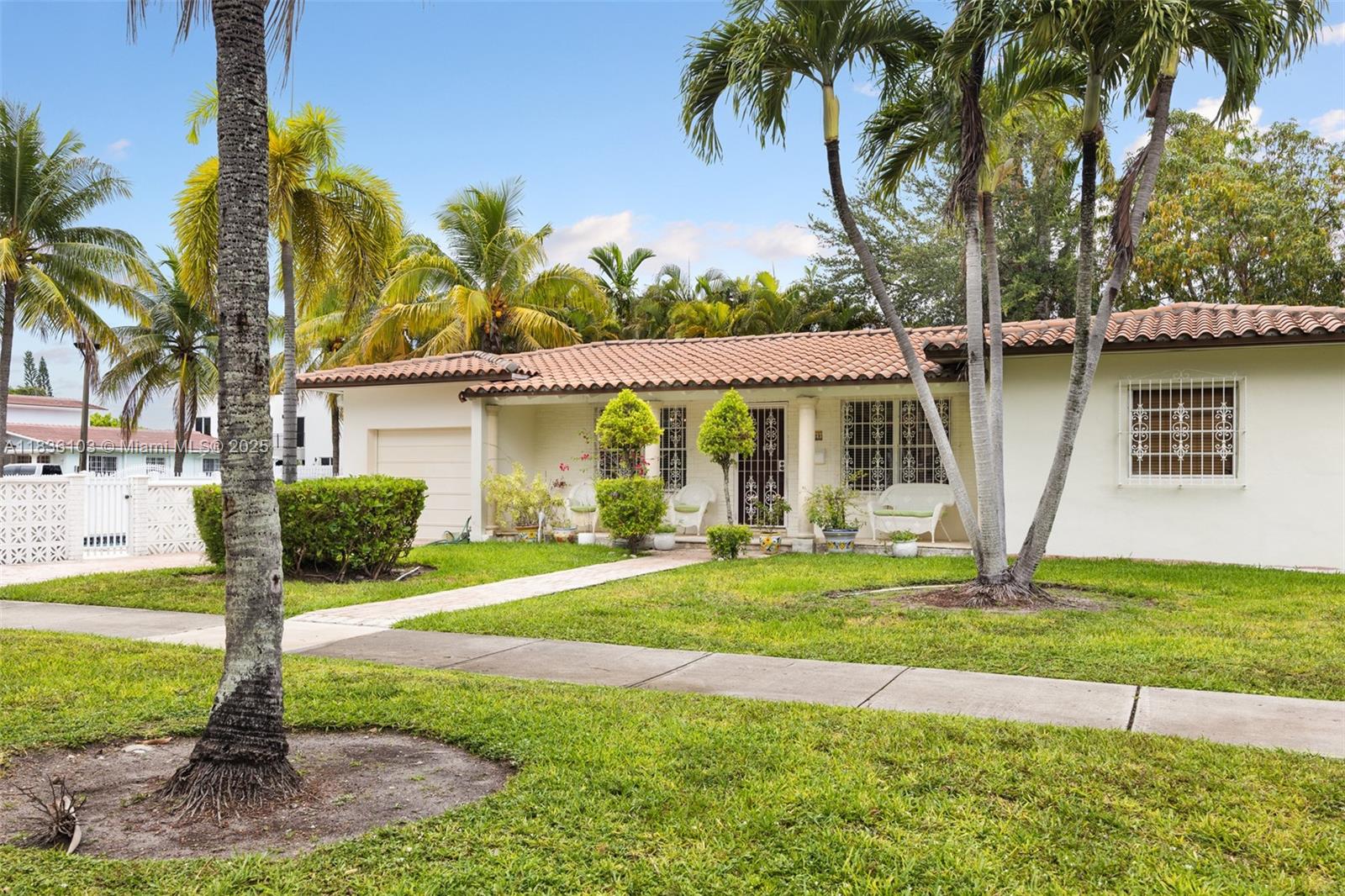811 Southwest 25th Road Miami, FL 33129 - Photo 3 of 23 a front view of a house with garden and trees