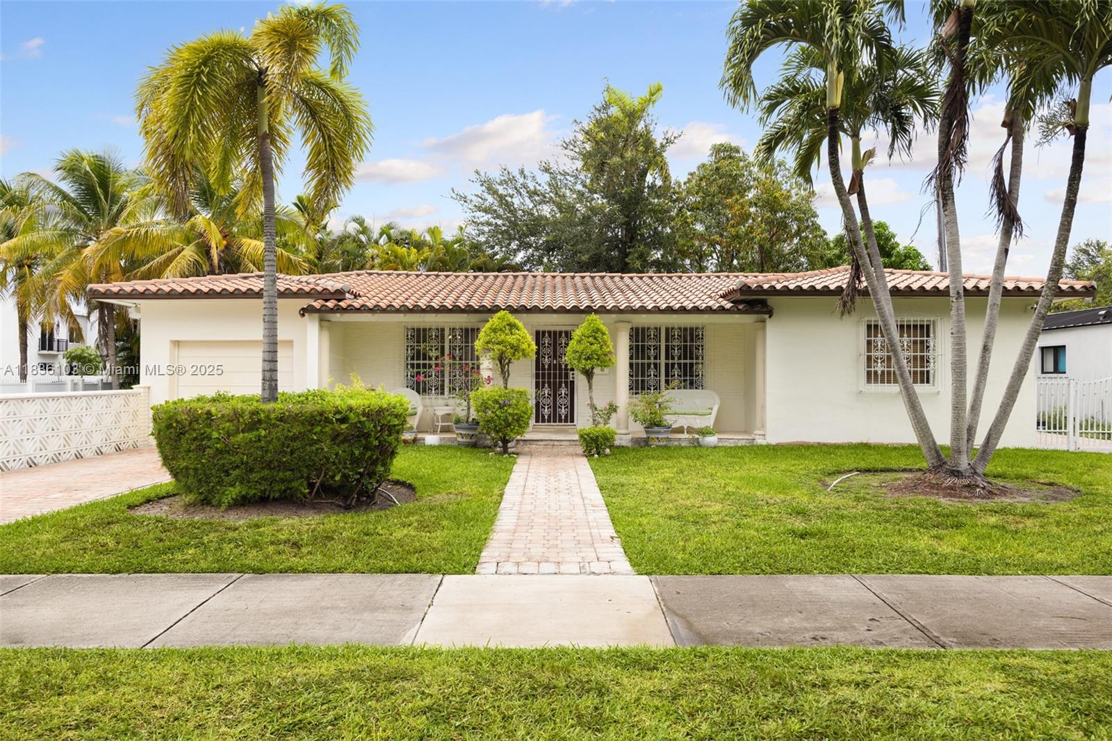 811 Southwest 25th Road Miami, FL 33129 - Photo 4 of 23 a front view of a house with a garden and yard