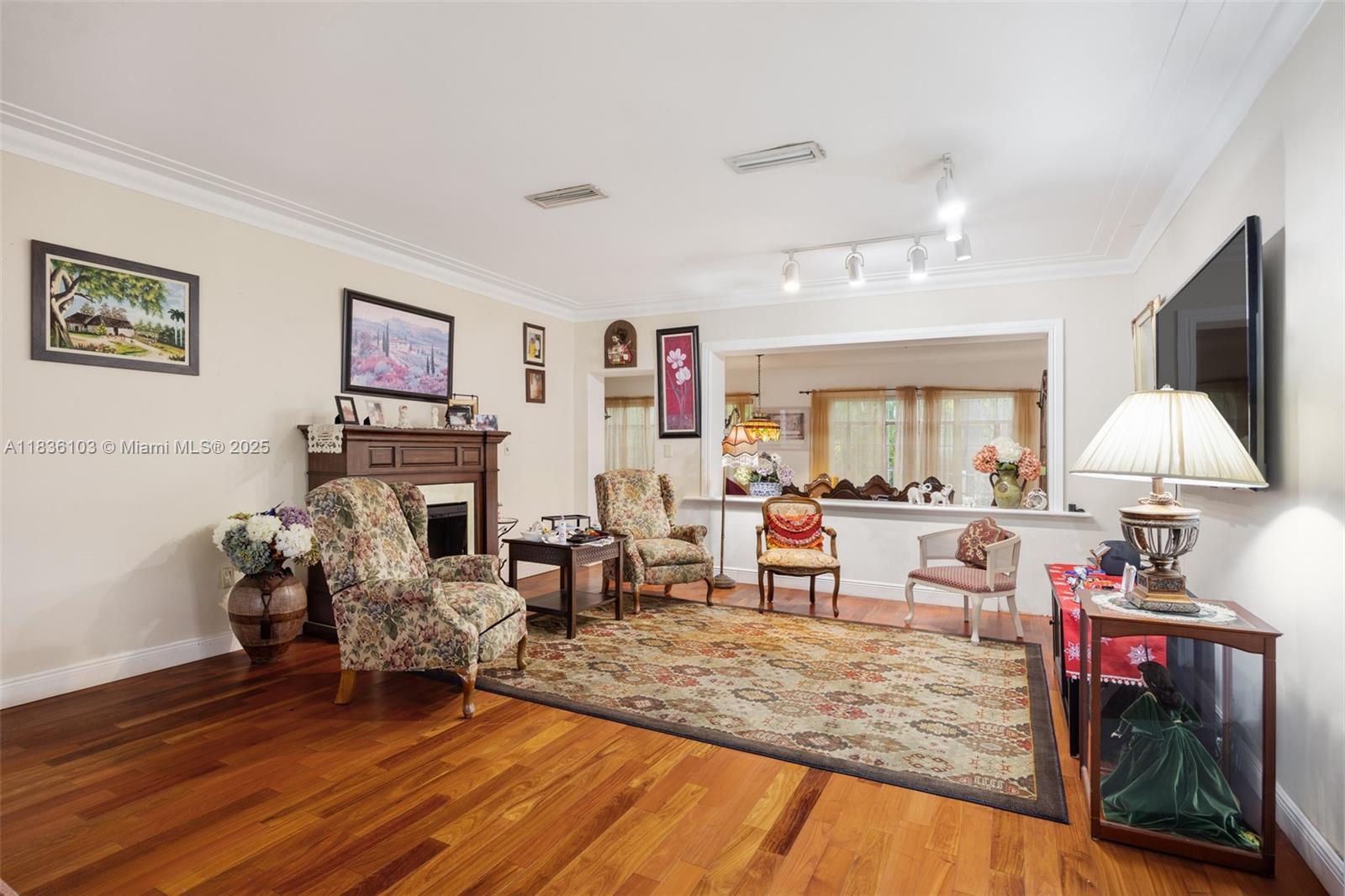 811 Southwest 25th Road Miami, FL 33129 - Photo 8 of 23 a living room with furniture and a flat screen tv