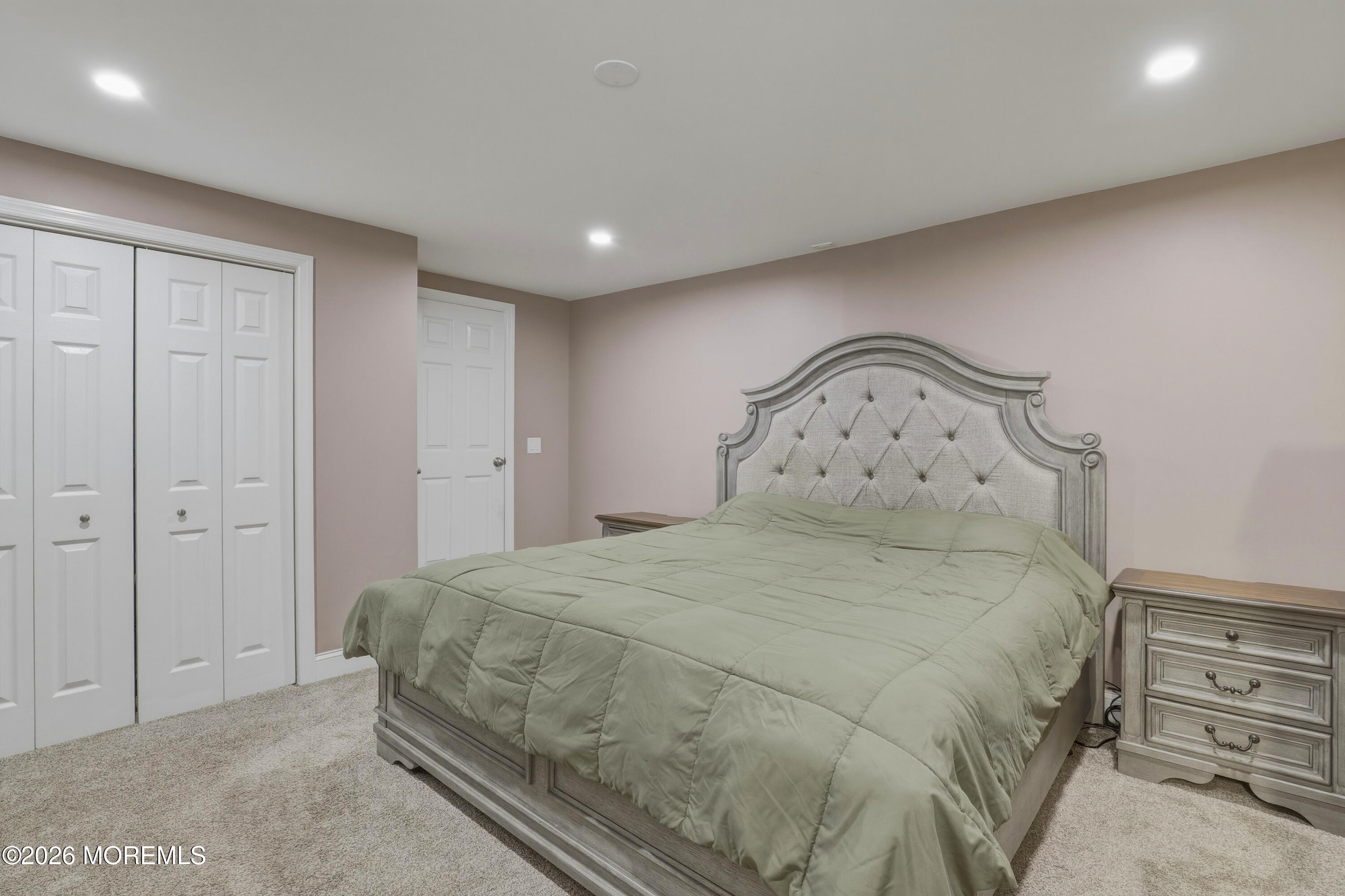578 High Street Long Branch, NJ 07740 - Photo 11 of 37 a large bed sitting in a bedroom next to a cabinet