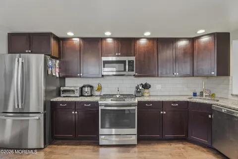 a kitchen with a sink stove and cabinets