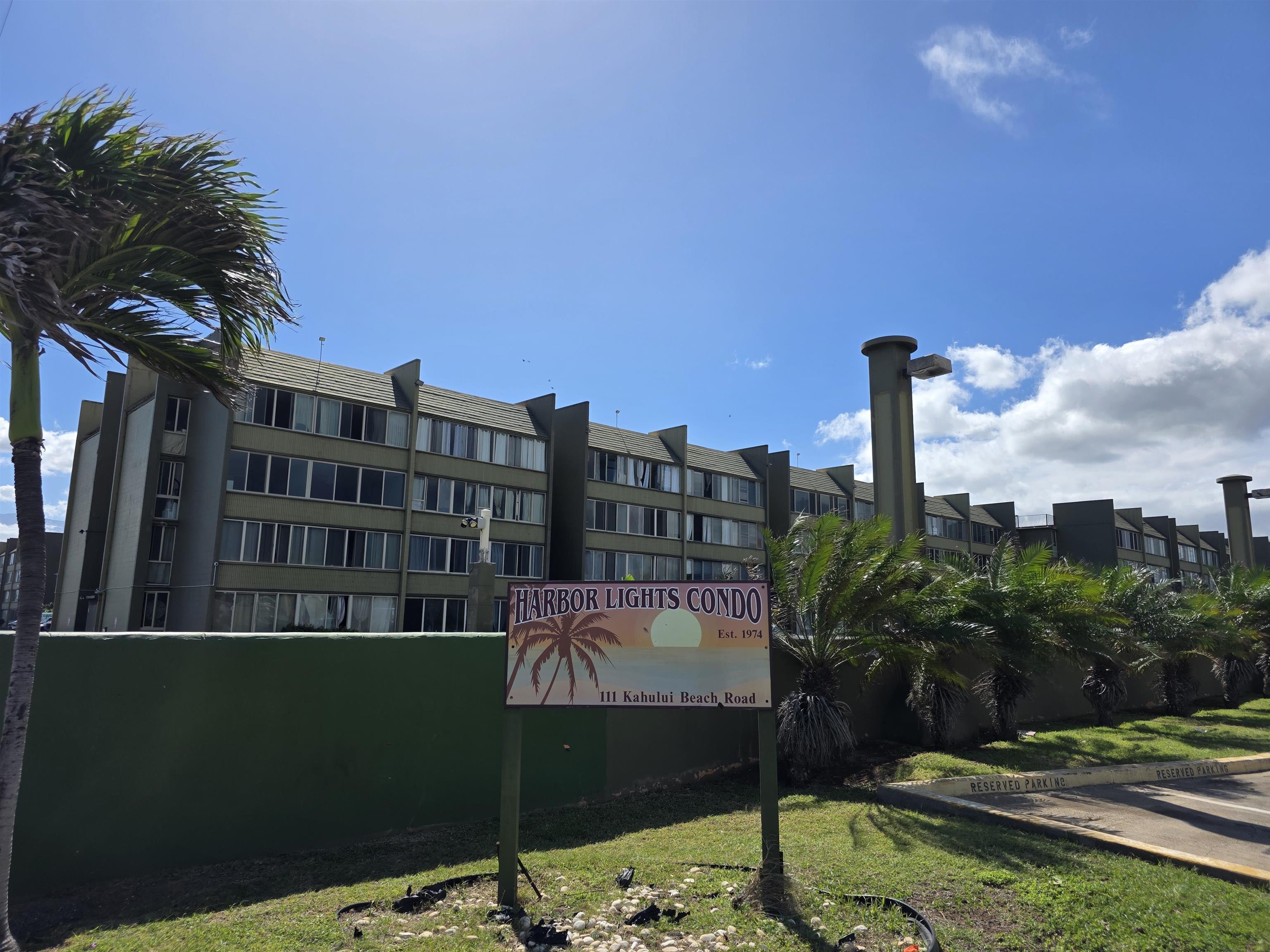 111 Kahului Beach Road, Unit B306 Kahului, HI 96732 - Photo 1 of 29 a view of tall buildings and a yard with swimming pool