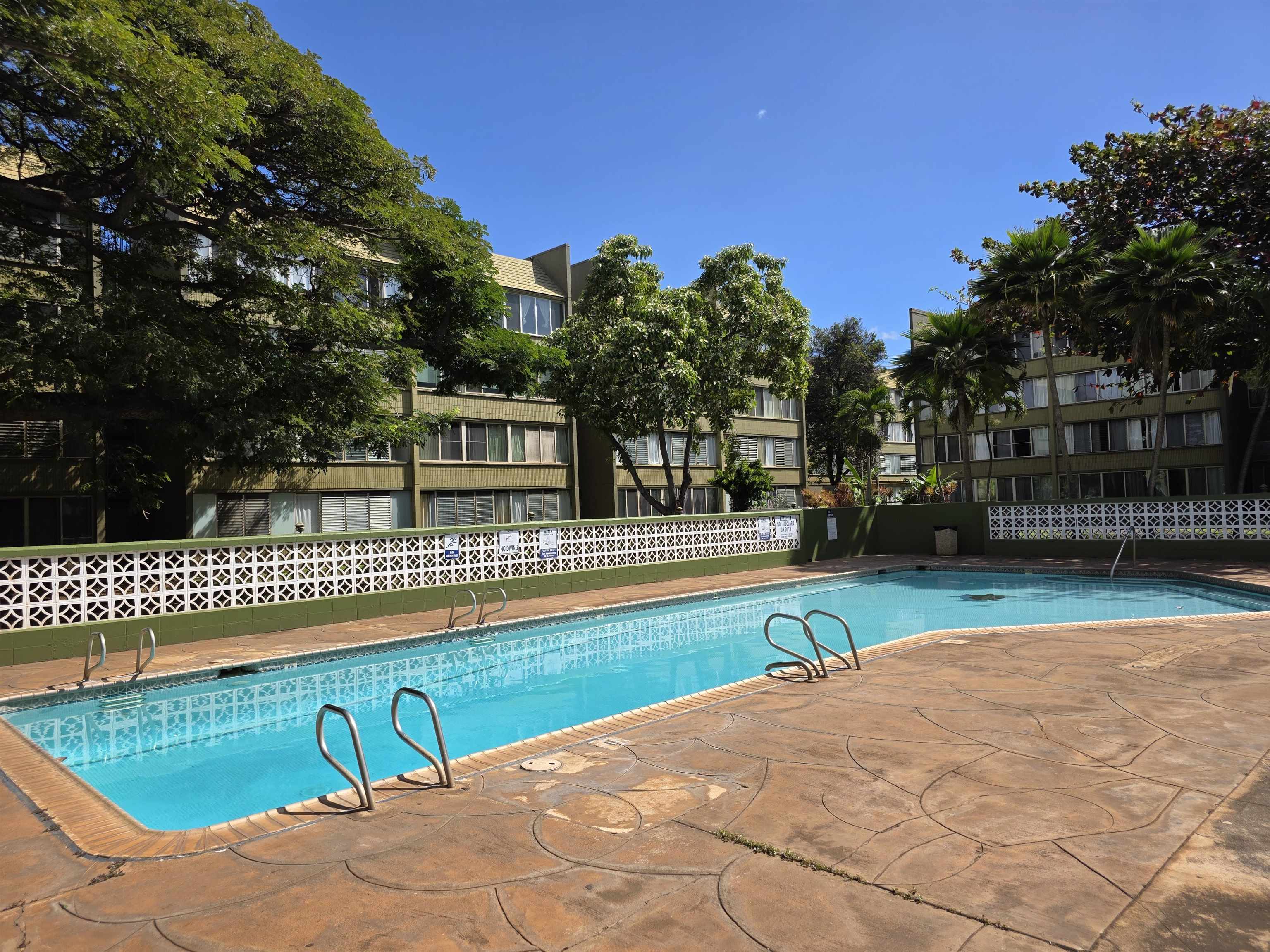 111 Kahului Beach Road, Unit B306 Kahului, HI 96732 - Photo 25 of 29 a view of swimming pool with outdoor seating and trees in the background