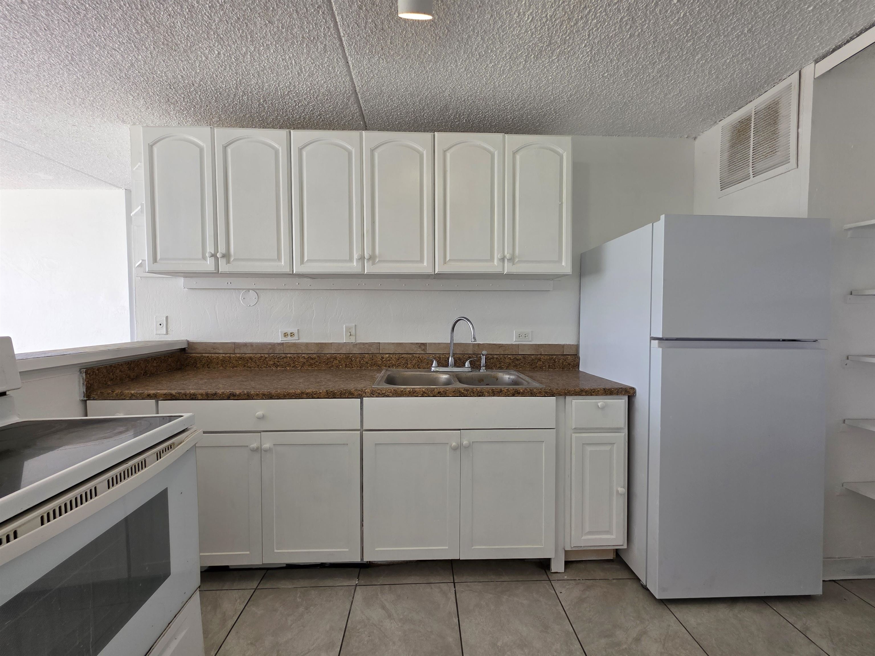 111 Kahului Beach Road, Unit B306 Kahului, HI 96732 - Photo 4 of 29 a kitchen with a sink and white stainless steel appliances