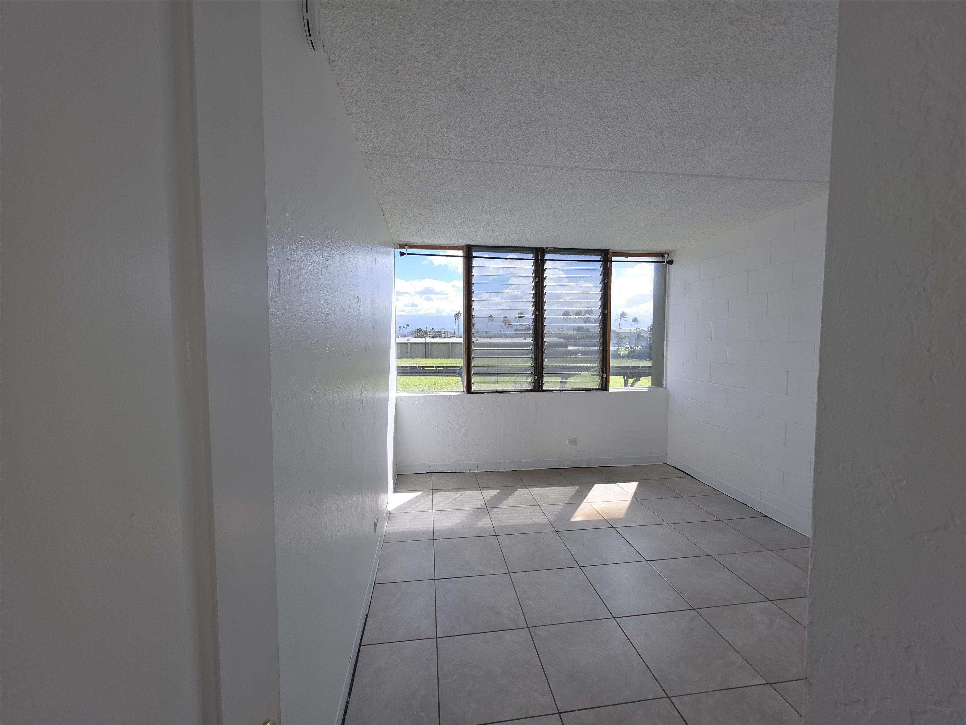 111 Kahului Beach Road, Unit B306 Kahului, HI 96732 - Photo 9 of 29 wooden floor in an empty room with a window