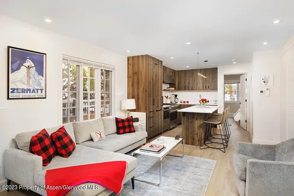 a living room with furniture and kitchen view