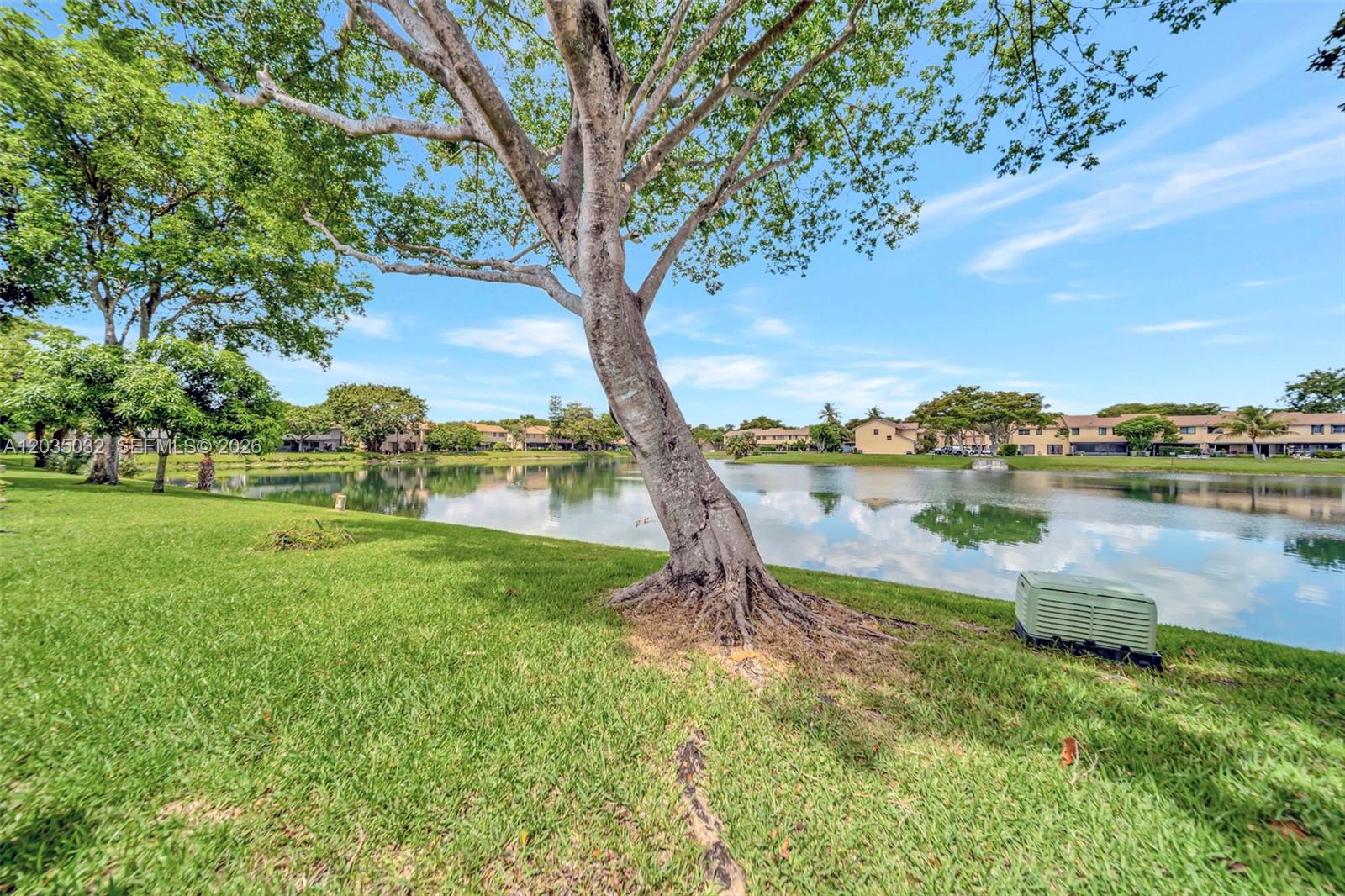 5223 Gate Lake Road, Unit 5223 Tamarac, FL 33319 - Photo 33 of 37 a view of a lake with houses in the back