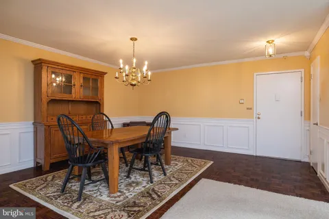 a kitchen with granite countertop a sink a stove a refrigerator and cabinets